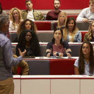 Students in a lecture hall listening to a lecturer
